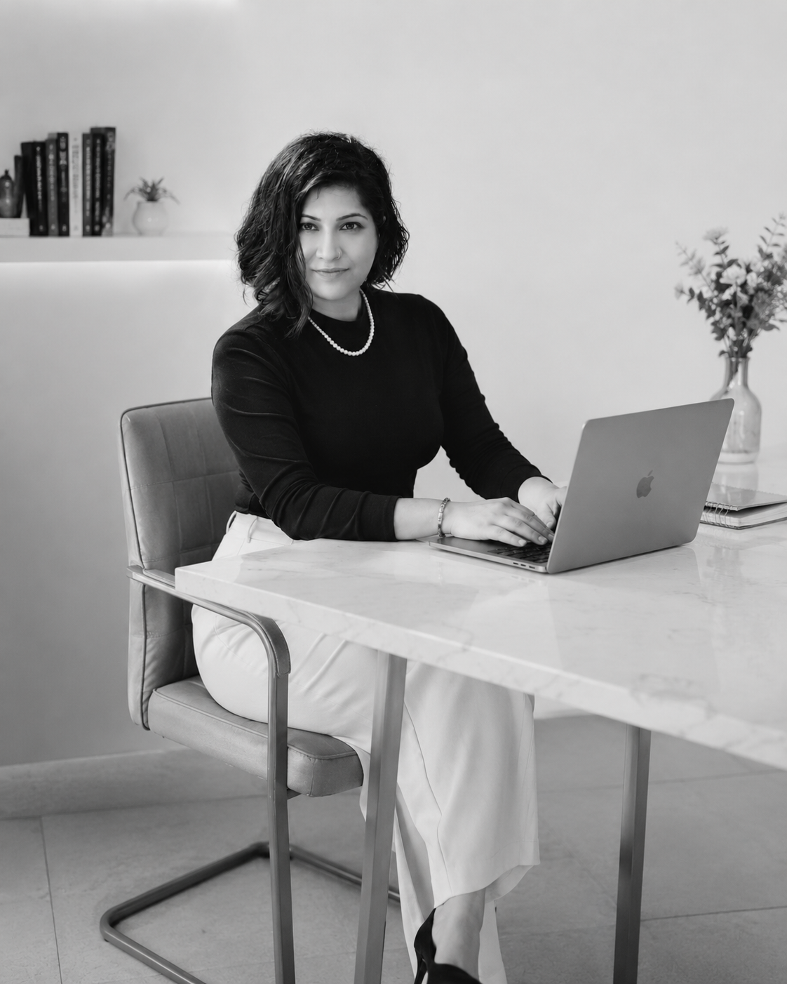 Preetjyot Kaur working at a marble desk